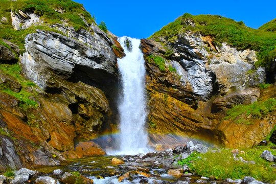 Waterfall flowing down a brown rockwall at Lieser stream in P&ouml;llatal in High Tauern, Carinthia, Austria