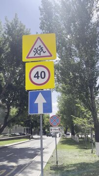 Road signs showing speed limit and traffic directions outdoors. transportation safety, urban infrastructure, public road.
