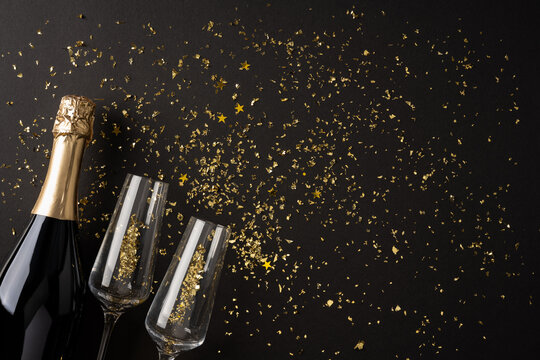Champagne bottle and flute with gold confetti for Happy New Year 2027 coming celebration and winter holiday