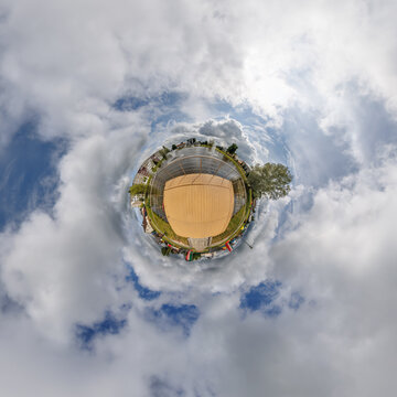 simple little tiny planet without buildings in blue sky with sun and beautiful clouds. Transformation of spherical panorama 360 degrees. Spherical abstract aerial view. Curvature of space.