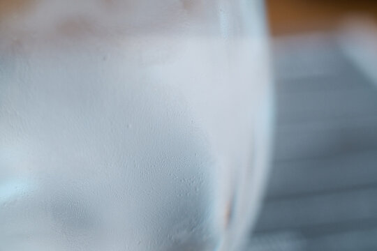 Close-up of a cold glass filled with sparkling water and tiny condensation droplets