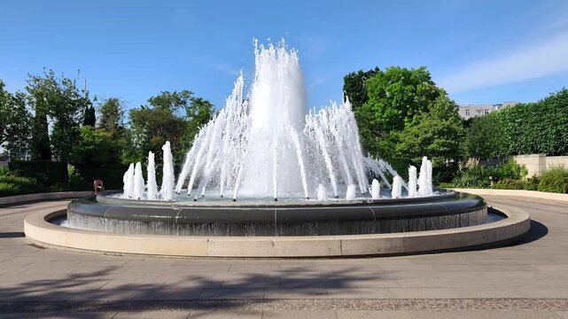 View of the elegant fountain in Amaliehaven Garden, Copenhagen, Denmark, featuring a striking sculptural centerpiece created by renowned Italian artist Arnaldo Pomodoro.