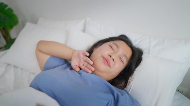 Asian plus-size woman sleep with headache and pain expression in house. 