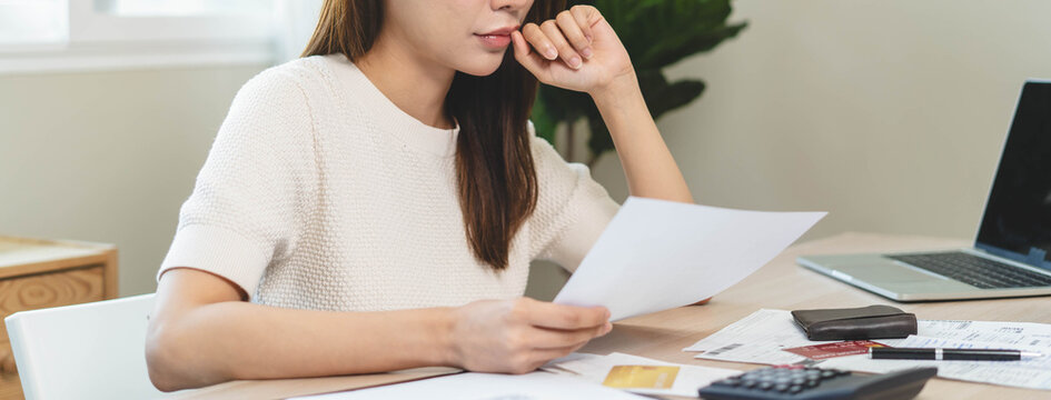 person using calculator calculating tax refund on the table