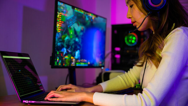 Game over you lose. Angry Asian gamer with gaming headphones playing video game on computer PC at home feeling sad disappointed about NFT game losing graph investors sulk down