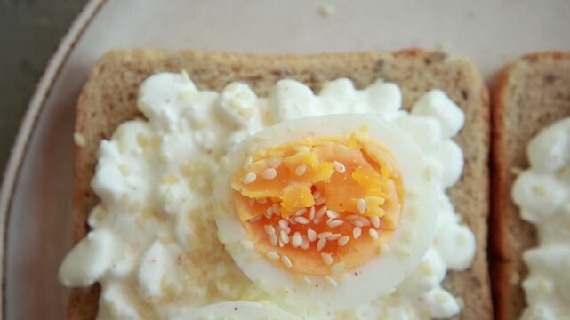 Healthy Toast with Cottage Cheese, Sliced Boiled Egg, and Sesame Seeds Close Up