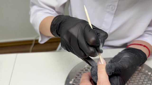  Slow‑motion manicure: orangewood stick pushing back cuticle &mdash; close‑up, 4K