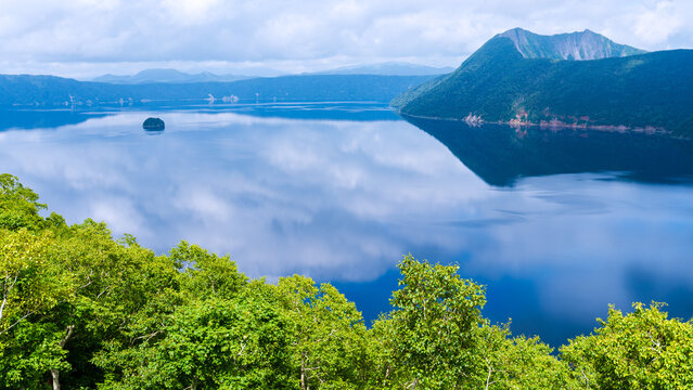 Lake Mashu reflecting clouds and Mount Mashu in eastern Hokkaido
