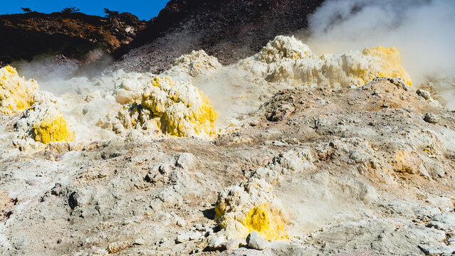 Yellow sulfur deposits and steaming fumaroles on Mount Io in Hokkaido