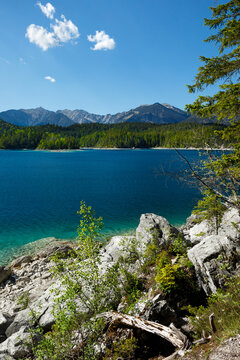 Travel landscape of Eibsee lake and  mountain peak in Alps in Bavaria,  Germany, scenic summer nature panorama with forest und mountains. Alpine landscape