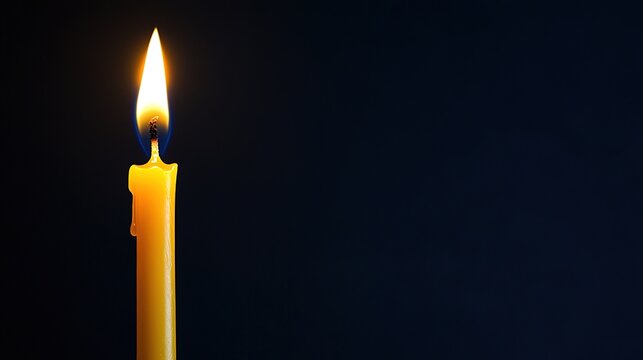 wax. A single birthday candle glowing softly, representing quiet celebration and warmth. symbolizing life milestones and joyful moments.