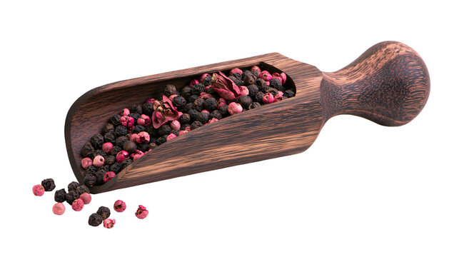 Wooden scoop filled with peppercorns and pink peppercorns