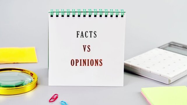 A display shows the words facts vs opinions on a small calendar. Nearby, there are office supplies on a flat surface. This shows a basic comparison