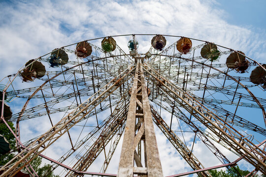 View of the Ferris wheel featuring a metal structure against a blue sky with clouds in Elektrenai, Vilnius County, Lithuania.