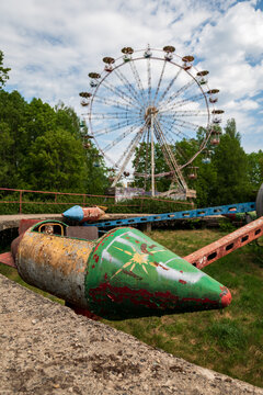 View of the abandoned rocket ride and ferris wheel in the old amusement park in Elektrenai, Vilnius County, Lithuania.