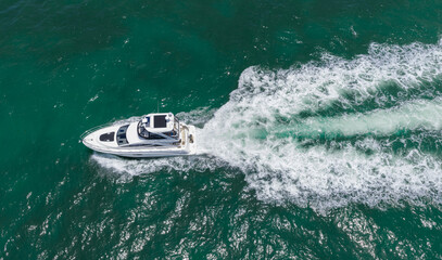 Naklejka premium Motorboat sailing at sea. Luxury private yacht in sea. Motor yacht luxury vessel. Boat motor aerial. Vacation on summertime. Aerial view motorboat. Yacht boat tour. Luxury boat yachting