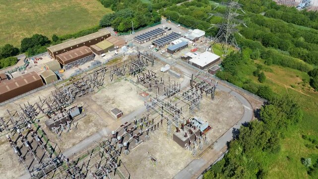 Aerial view of National Grid Thorpe Marsh Substation with electrical transformers and industrial buildings in Barnby Dun, England, United Kingdom.