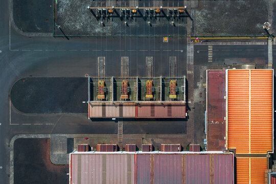 Aerial view of an industrial facility with electrical transformers and large metal-roofed buildings in Sao Miguel, Azores, Portugal.