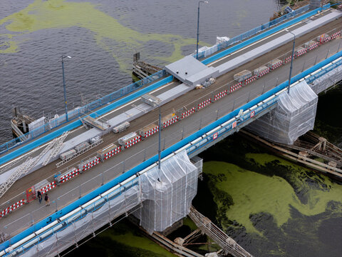 Aerial view of the bridge under construction with scaffolding and protective sheeting over the water in Gdansk, Pomeranian Voivodeship, Poland.