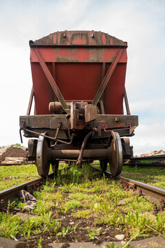 View of a weathered red freight wagon on railway tracks at the Port of Ventspils, Ventspils, Ventspils Municipalit, Latvia.