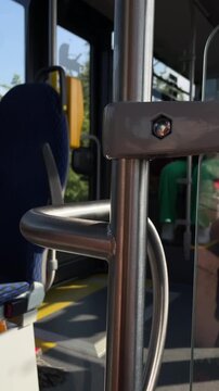 close-up motion view of stainless steel grab rail and vertical pole inside urban bus interior showing curved brushed metal rail with weld seam and hex bolt mounted