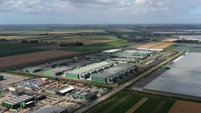 Aerial view of the Microsoft datacenter surrounded by vast agricultural fields and greenhouses in Middenmeer, Noord-Holland, Netherlands.