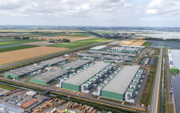 Aerial view of the Microsoft datacenter complex surrounded by agricultural fields and greenhouses in Middenmeer, Noord-Holland, Netherlands.