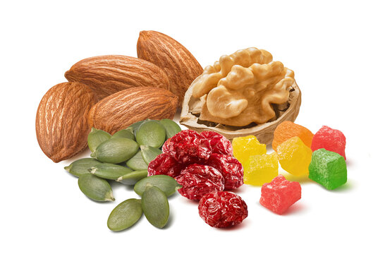 Walnut and almond nuts, green pumpkin seeds, cranberry and candied fruit isolated on white background