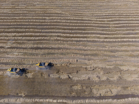 Aerial view of two combine harvesters working in a large wheat field at Tigem Altinova Tohum Yetistirme Mudurlugu in Kadinhani, Konya, Turkiye.