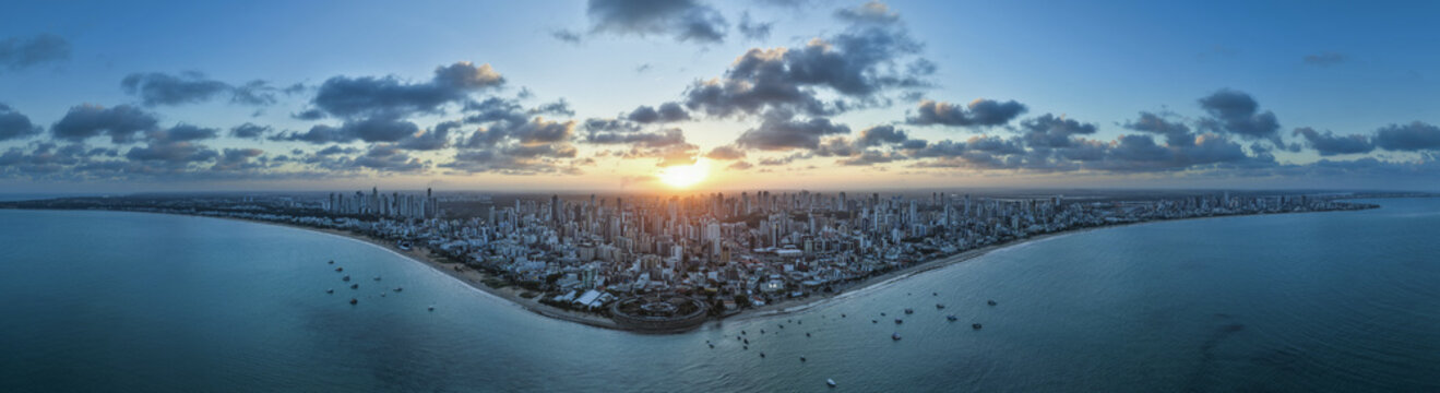 Aerial view of the coastal skyline of Joao Pessoa at sunset, featuring modern high-rise buildings along the Atlantic Ocean coastline in Joao Pessoa, Paraiba, Brazil.