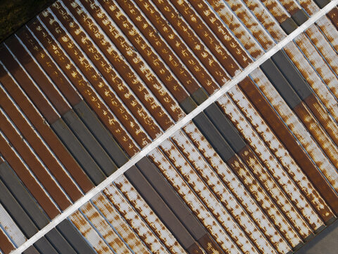 Aerial view of corrugated metal roof panels with alternating rusted and dark grey sections in Krakow, Lesser Poland Voivode, Poland.