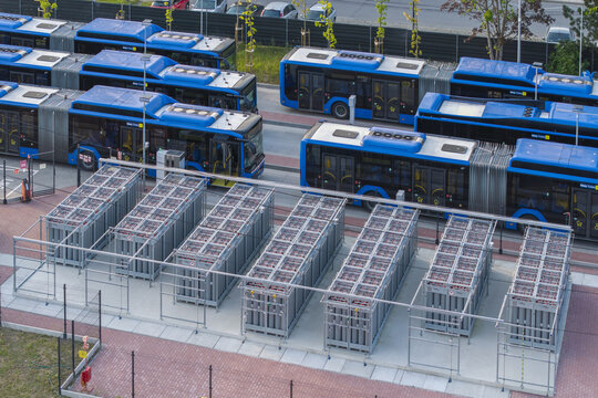 Aerial view of the LNG and CNG bus station with rows of blue buses parked next to industrial gas storage containers in Krakow, Lesser Poland, Poland.
