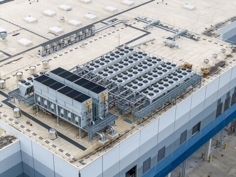 Aerial view of the Lidl logistics center under construction featuring large HVAC units and cooling systems on the industrial roof in Skawina, Lesser Poland Voivode, Poland.