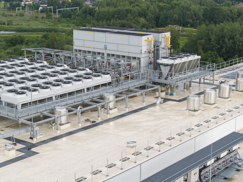 Aerial view of the industrial rooftop of the Lidl logistics center under construction, featuring large HVAC cooling units and ventilation systems, Skawina, Lesser Poland Voivode, Poland.