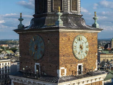 Aerial view of the historic Town Hall Tower in Krakow Old Town with its prominent brick facade and clock faces overlooking the city rooftops in Krakow, Lesser Poland Voivode, Poland.
