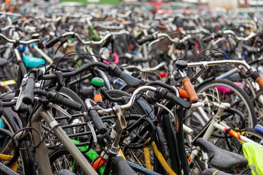View of a dense collection of bicycles parked in a crowded urban bicycle parking area in the Netherlands.