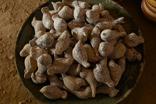 View of hand-painted ceramic bird figurines in a bowl, representing traditional Hala pottery craftsmanship in Hala, Sindh, Pakistan.