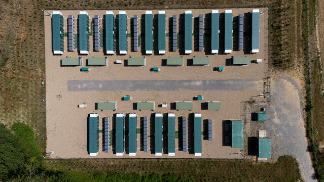 Aerial view of a data centre facility featuring rows of modular units arranged on a gravel surface in Hatfield, England, United Kingdom.