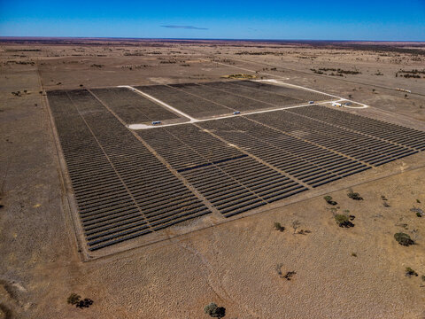 Aerial view of the Camden Park solar farm featuring rows of solar panels in the arid outback landscape of Longreach, Queensland, Australia.