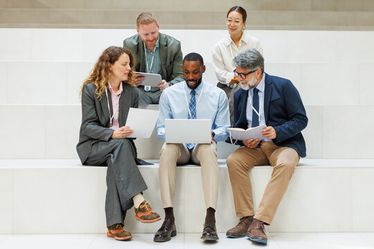 Business colleagues review a strategy on indoor steps