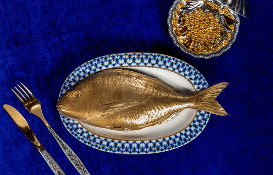 Golden fish and caviar represent a surreal metaphor for inflation