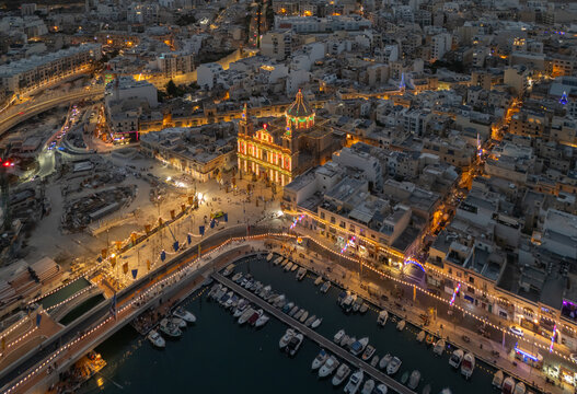 Aerial view of Msida marina and church during Malta festa at dusk with lights