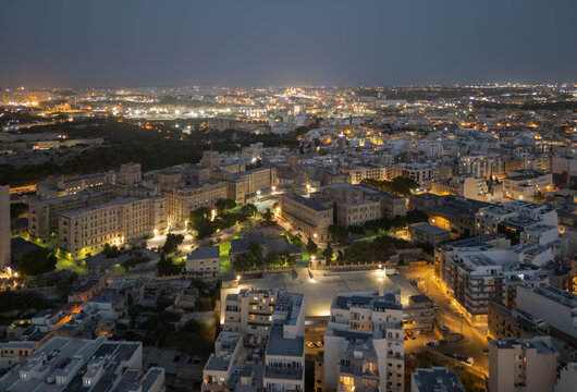 Aerial view of St Luke's Hospital in Pieta, Malta, illuminated at dusk