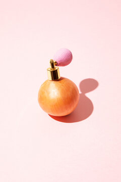 Surreal concept of an onion with a vintage perfume atomizer spray