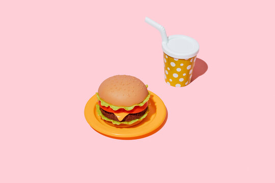 Plastic toy hamburger and drink cup sit on a pink background