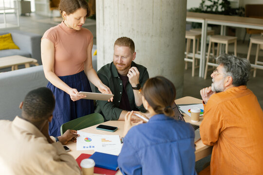 Businesswoman presenting ideas to her team during a meeting in an office