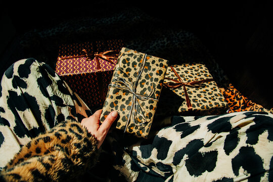 Woman takes a stylish leopard print holiday gift indoors