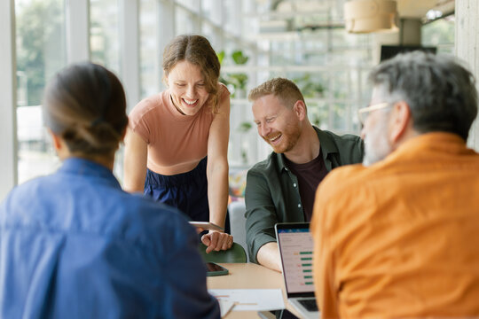 Business colleagues share ideas during a meeting at the office