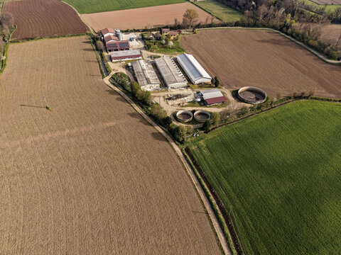 Aerial view of a cattle farm featuring rooftop solar panels, sustainable agricultural practices, and renewable energy integration in Mediglia, Lombardy, Italy.