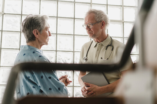 Male doctor advises female patient during a hospital consultation